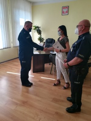 obrazek przedstawia Komendanta Policji w Żninie nadkom. Mariusza Gaika, który wręcza list gratulacyjny st. asp. Joannie Cabała