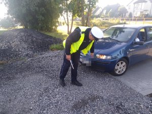 na zdjęciu widoczny jest policjant podczas kontroli drogowej