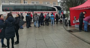dawcy krwi  ustawieni przed autobusem Centrum Krwiodawstwa
