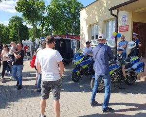 ludzie gromadzą się koło policyjnych  motocykli